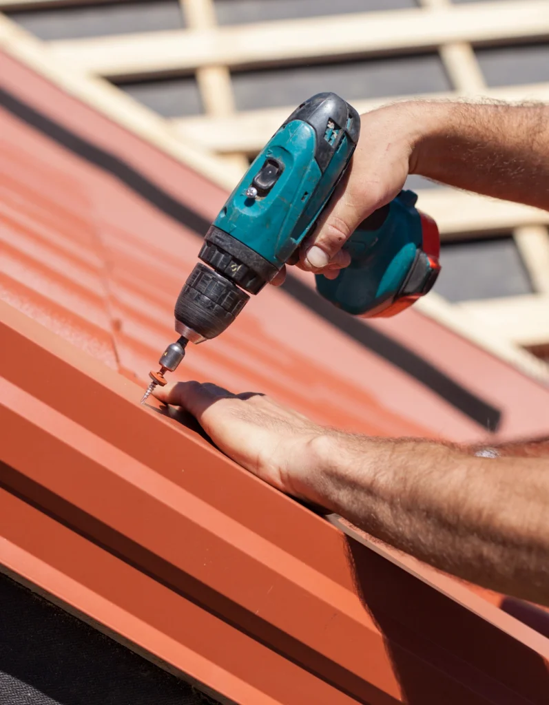 a-man-using-a-drill-to-fix-a-roof